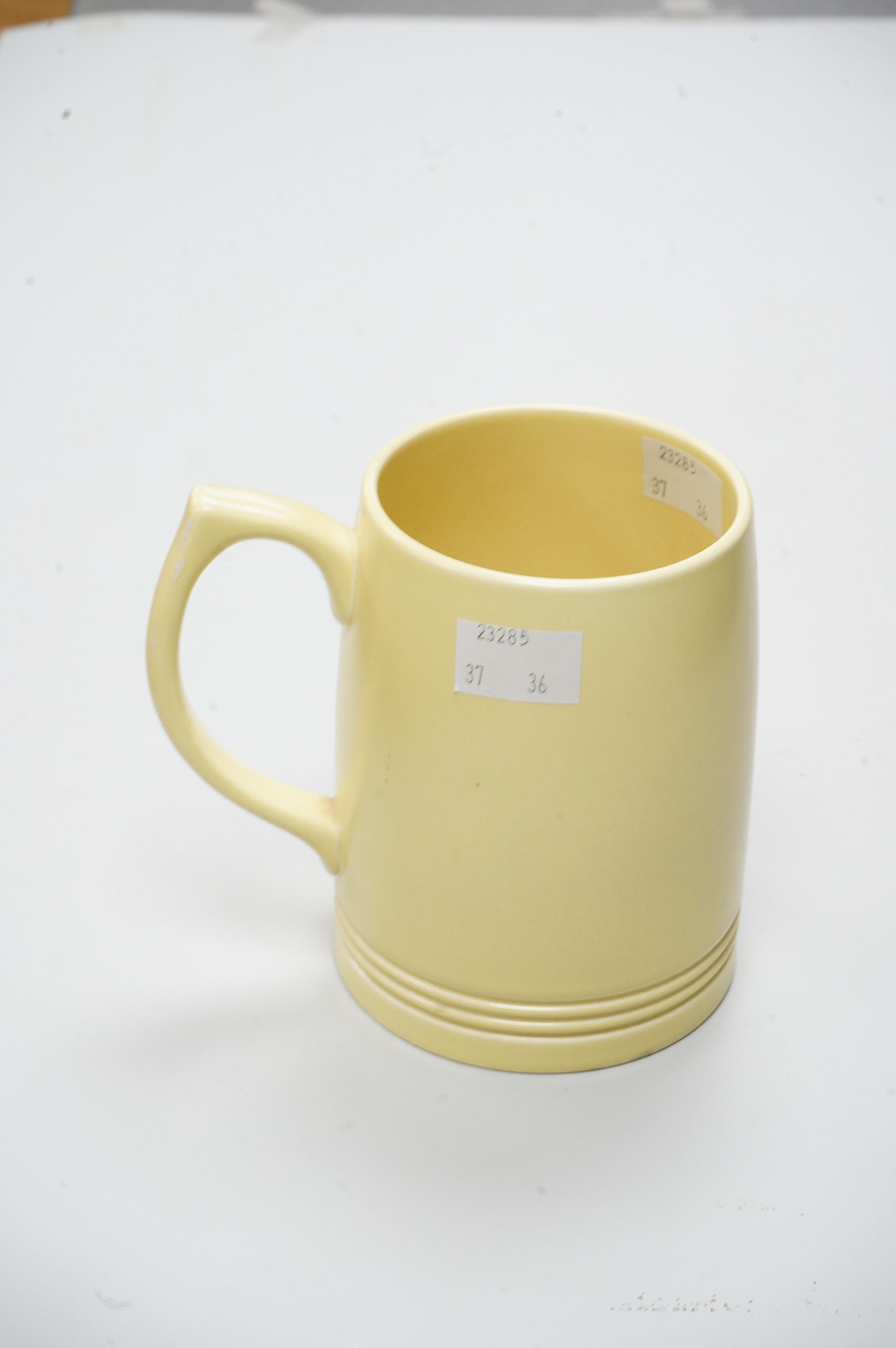 A Keith Murray Wedgwood mug in matt straw, 12cm